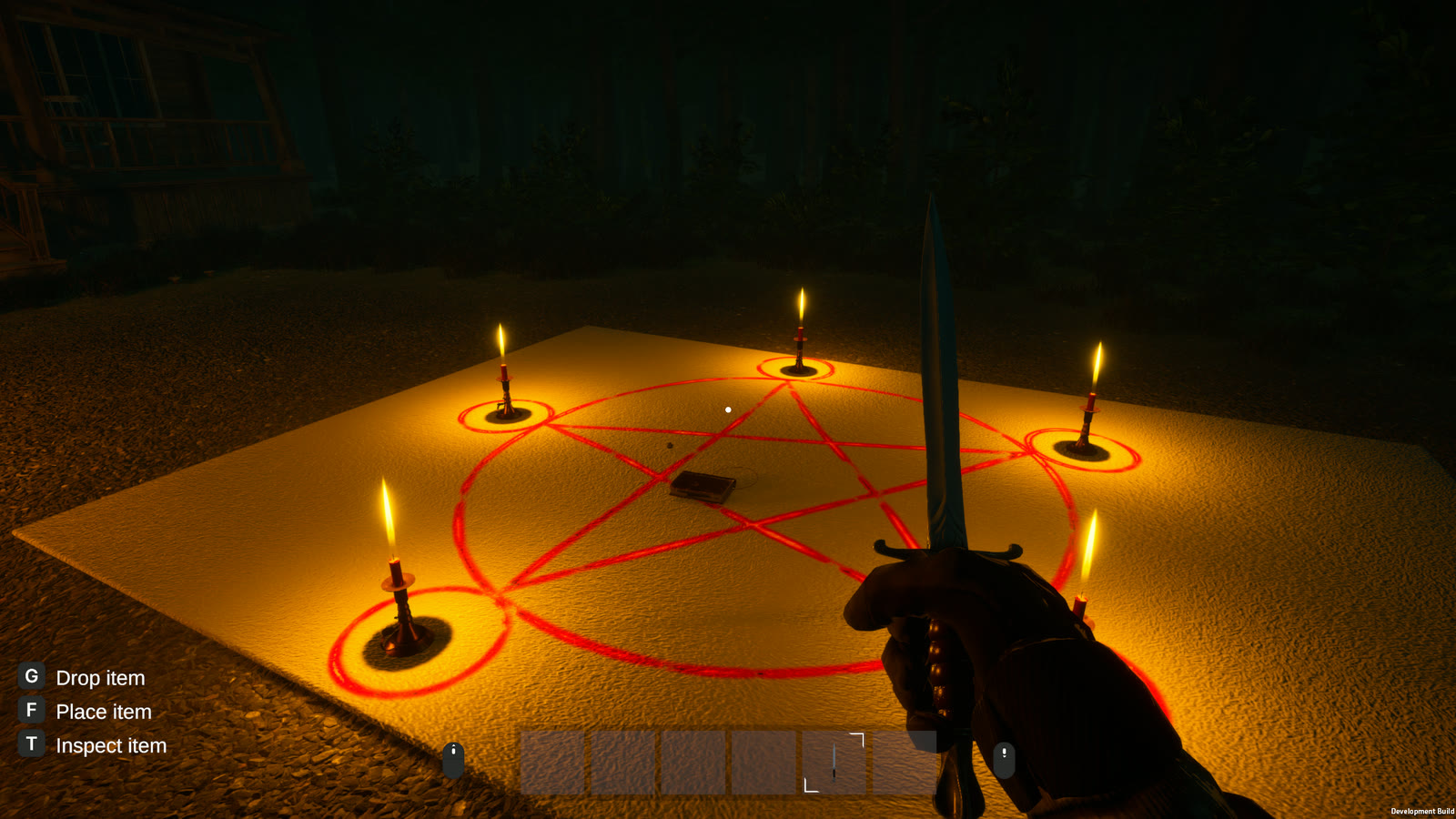 A dagger held over a red pentagram painted on a canvas sheet, a candle burning at each of its five points.